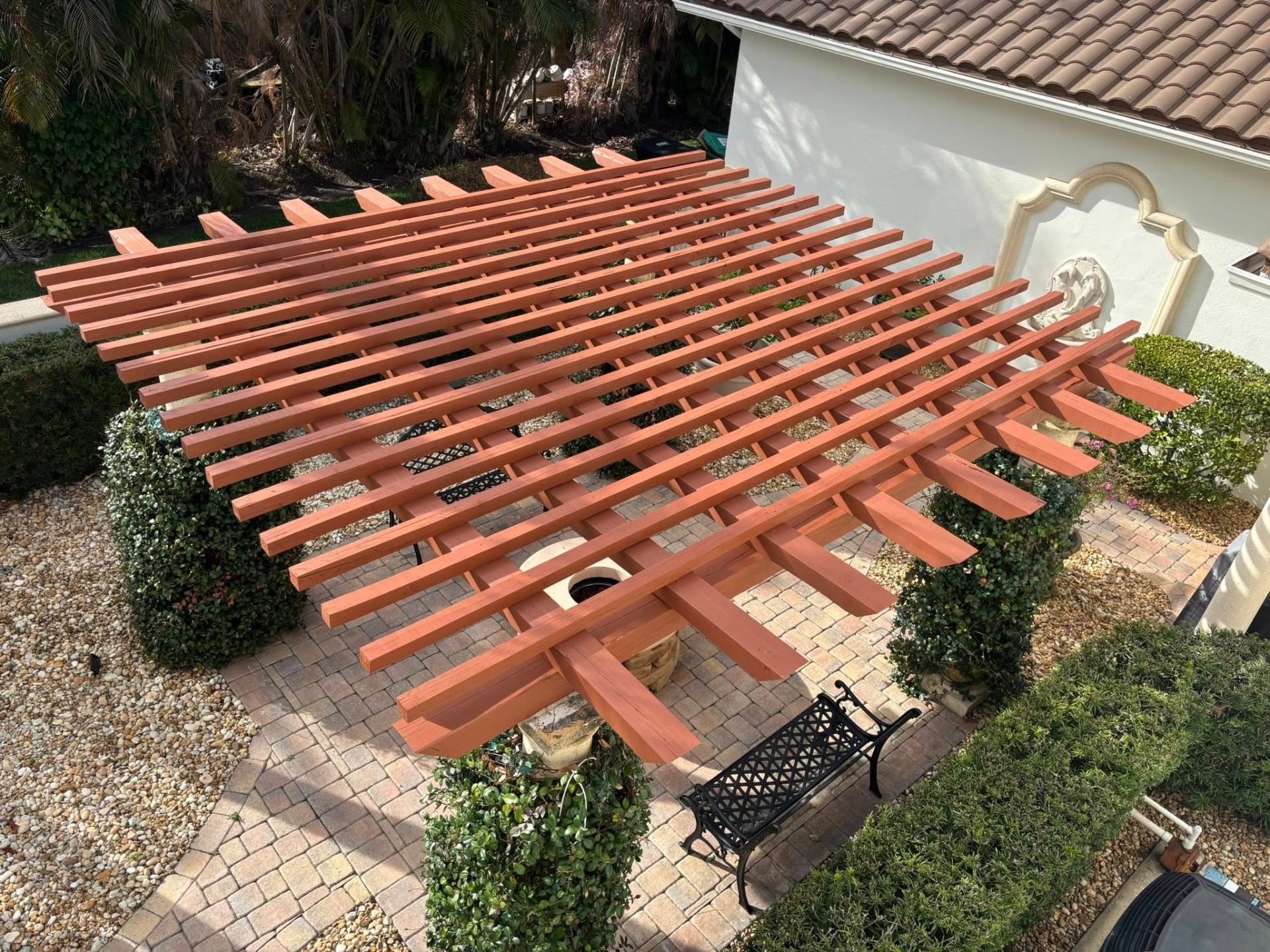 Newly stained wood pergola on a Florida home exterior after professional exterior painting